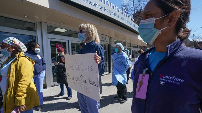 Members of the medical staff listen as Montefiore Medical Centre nurses call for N95 masks and other “critical’’ PPE to handle the coronavirus (COVID-19) pandemic.