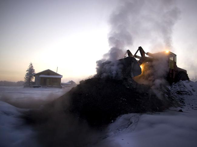 A digger delivers fresh coal to the heating plant in Oymyakon Village of Oymyakon, which is considered to be the coldest permanently inhabited settlement in the world, Russia. Picture: Amos Chapple/REX/Shutterstock/Australscope