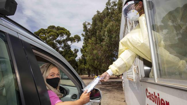 Ellie Wilkinson picks up her rapid antigen tests from the collection site in Adelaide’s Southern Parklands off Greenhill Rd. Picture Emma Brasier