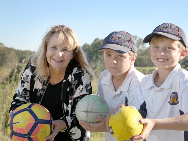 Council has allocated money in the budge for planning work to start on Griffin sports complex. Cr Julie Greer with Austin and Theo Tsingos (griffin) on the site of the new ovals. Picture: Chris Higgins