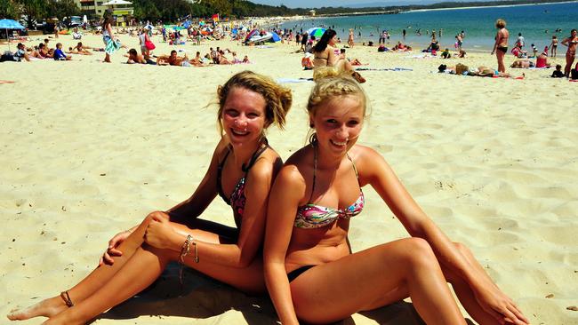 Taylor Peake (left) and Lauren Campbell from the Gold Coast enjoy Main Beach and the brilliant weather while they holiday in Noosa in 2009. Picture: Geoff Potter