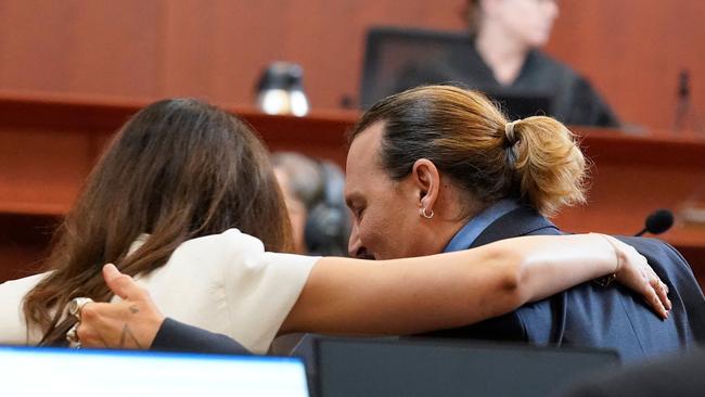 Ms Vasquez embraces Depp during the trial. Picture: Steve Helber / Pool / AFP