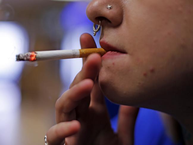 FILE - In this July 17, 2015, file photo, store manager Stephanie Hunt smokes a Marlboro cigarette while posing for photos at a Smoker Friendly shop in Pittsburgh. Altria Group Inc., maker of Marlboro cigarettes, reports financial results on Wednesday, July 27, 2016. (AP Photo/Gene J. Puskar, File)