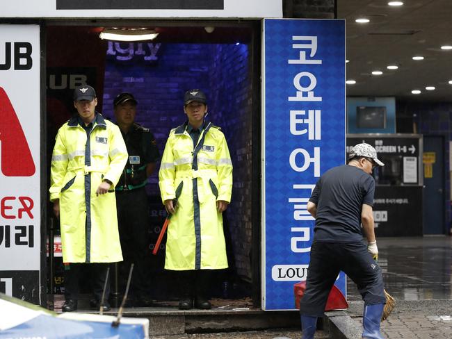 Police stand at the doorway to the nightclub in Gwangju, South Korea. Picture: AP