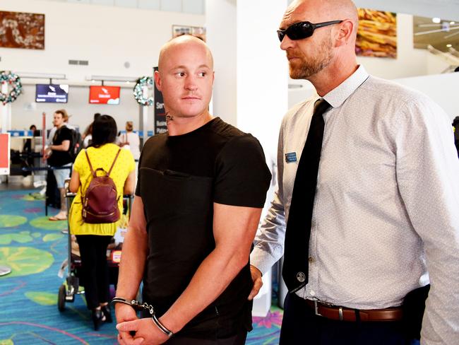 Kane O'Meley being extradited back to Sydney after being accused of biting off part of a man's ear in a pub fight on the Central Coast. He was arrested in Darwin after fleeing to the Top End.