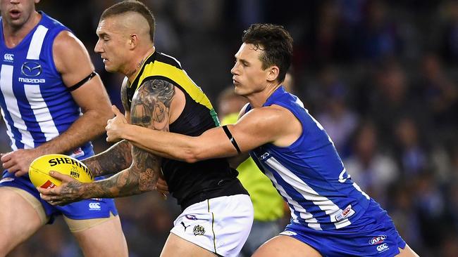 Dustin Martin is tackled by Ben Jacobs.