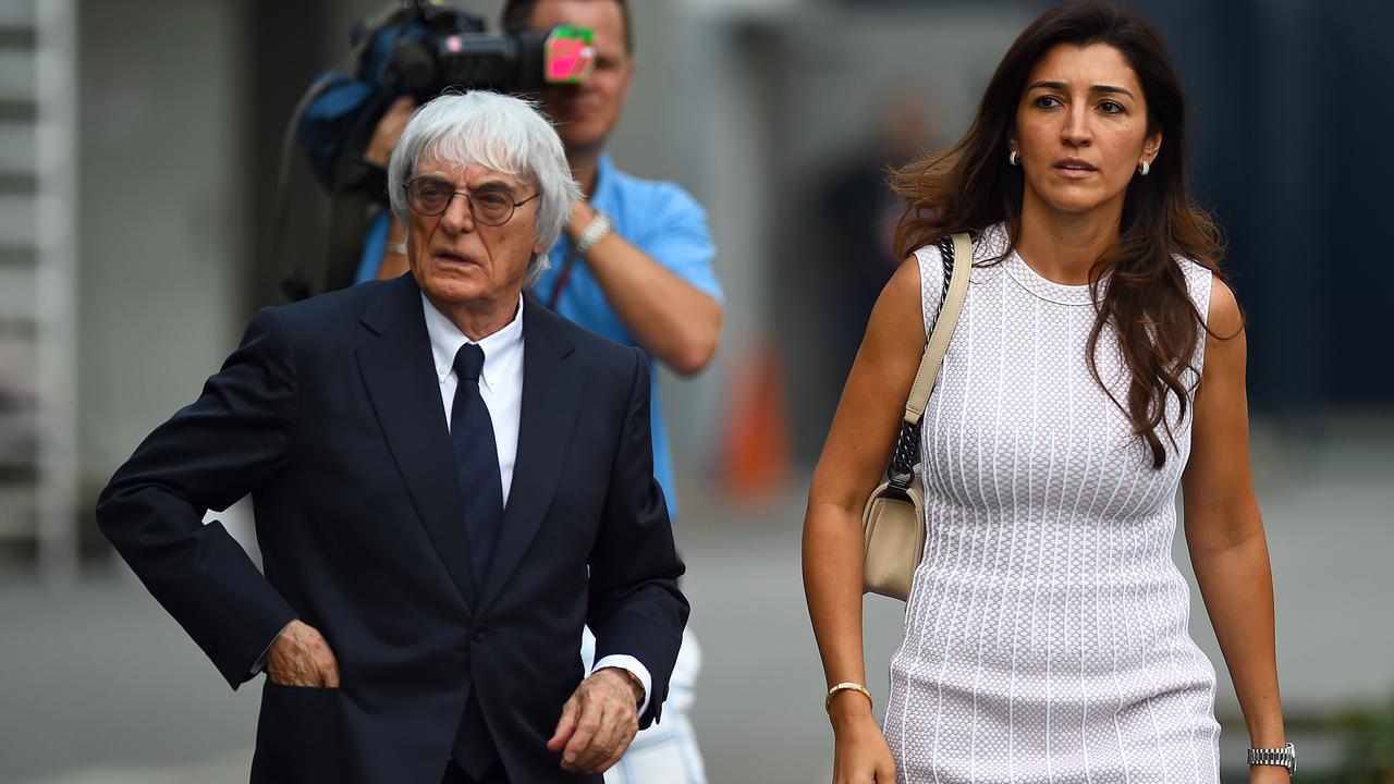 F1 supremo Bernie Ecclestone walks through the paddock with his wife Fabiana Flosi. (Photo by Lars Baron/Getty Images)