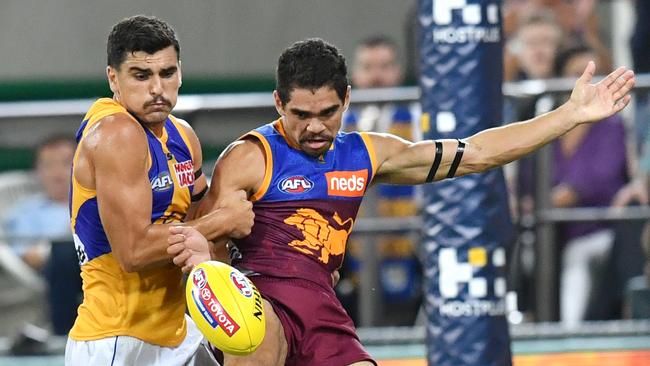 Brisbane’s Charlie Cameron prepares to kick a super goal despite the efforts of Tom Cole. Picture: AAP