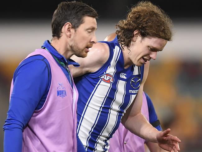 BRISBANE, AUSTRALIA - AUGUST 05: Ben Brown of the Kangaroos walks off the field injured during the round 10 AFL match between the Geelong Cats and the North Melbourne Kangaroos at The Gabba on August 05, 2020 in Brisbane, Australia. (Photo by Albert Perez/AFL Media/via Getty Images)