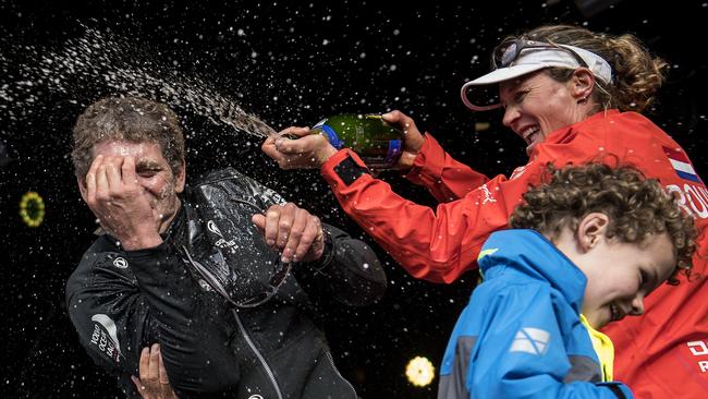 Carolijn Brouwer spraying champagne on French skipper Charles Caudrelier as they celebrate winning the Volvo Ocean Race in Scheveningen, The Hague, in 2018.