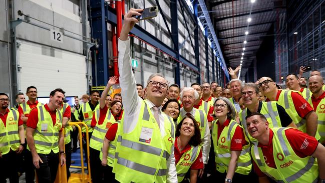 Prime Minister, Anthony Albanese poses for a 'selfie' with Coles team members, including chief executive Leah Weckert at the new Automated Distribution Centre at Coles Kemps Creek. Picture: Brendon Thorne/Getty Images