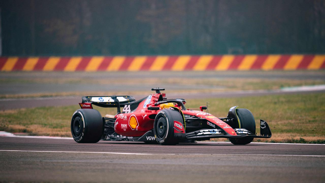 Lewis Hamilton drives his first laps in a Ferrari. (Photo by Handout / FERRARI / AFP)