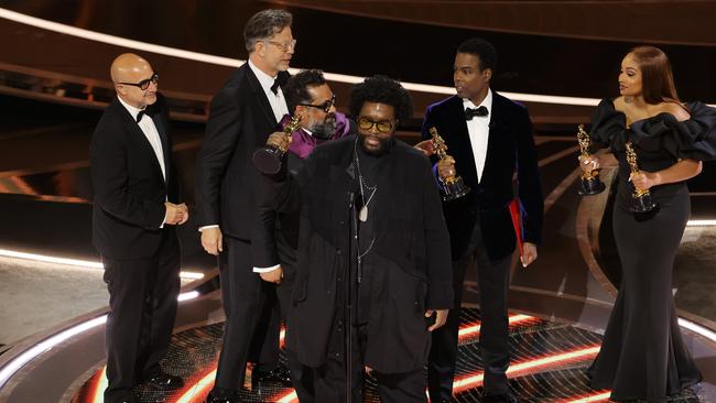 After being slapped by Will Smith, Rock carried on presenting the best documentary award to director Questlove and the film’s three producers. Picture: Getty Images.