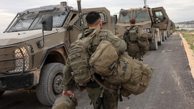 Israeli troops and military vehicles prepare to enter Jenin in the occupied West Bank, near the Israeli village of Muqeibila on Thursday. Picture: AFP