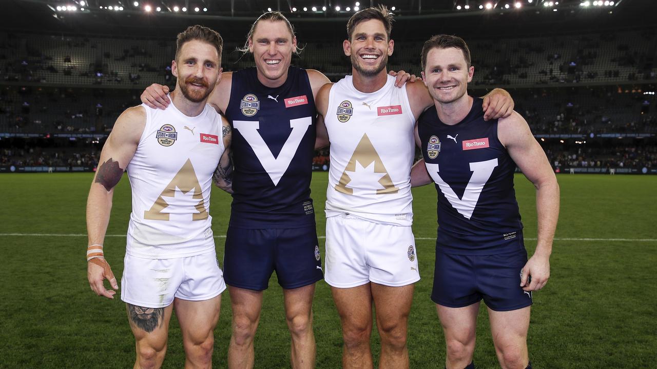 MELBOURNE, AUSTRALIA - FEBRUARY 28: Zach Tuohy and Tom Hawkins of the All Stars pose for a photo with Mark Blicavs and Patrick Dangerfield of Victoria during the 2020 State of Origin for Bushfire Relief match between Victoria and the All Stars at Marvel Stadium on February 28, 2020 in Melbourne, Australia. (Photo by Dylan Burns/AFL Photos via Getty Images)