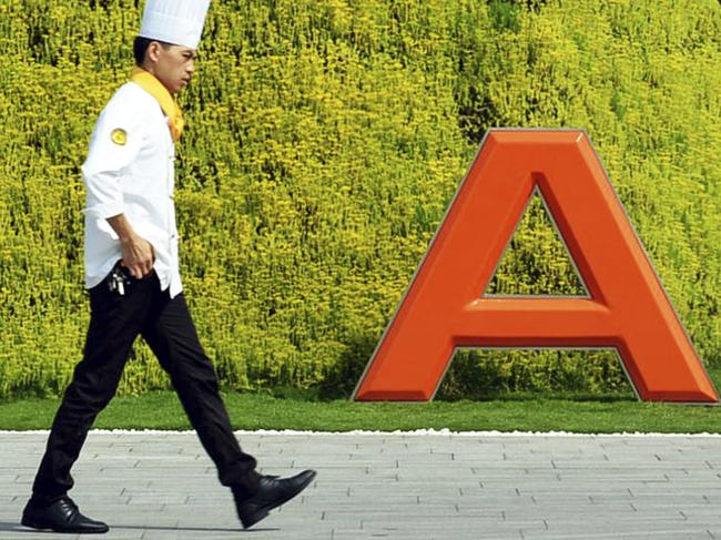 In this photo taken on Aug. 27, 2014, a chef walks in the headquarter campus of Alibaba Group in Hangzhou in eastern China's Zhejiang province Foreigners who want to buy Alibaba Group shares in the Chinese e-commerce giant’s U.S. public offering will need to get comfortable with an unusual business structure.(AP Photo) CHINA OUT