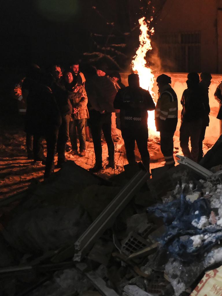 Rescue volunteers take a break during a search operation in Elbistan. Picture: Mehmet Kacmaz/Getty Images