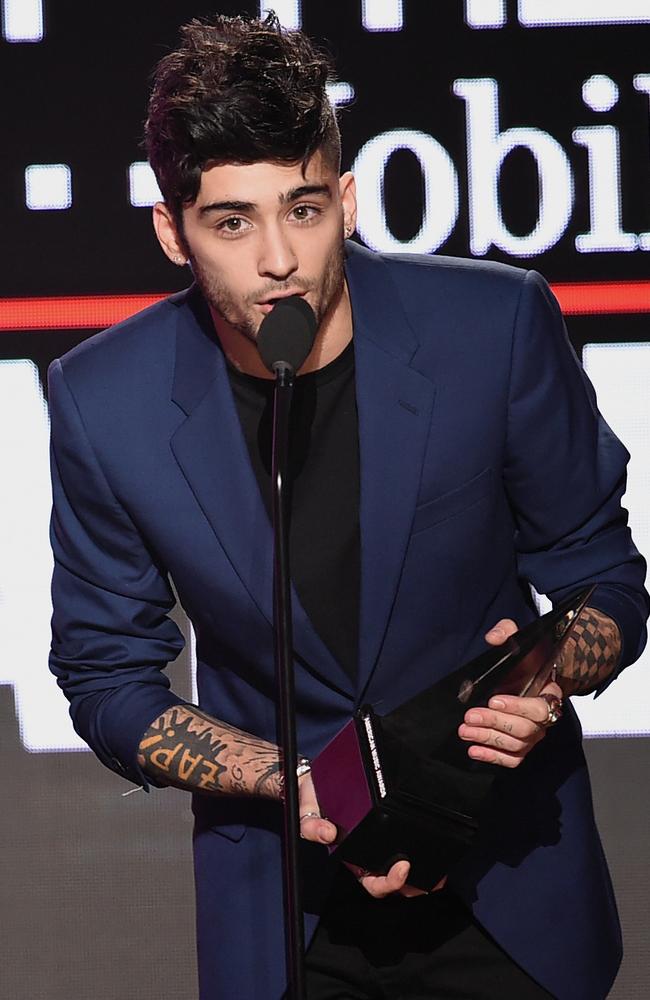 Zayn Malik accepts his New Artist of the Year gong at the AMAs. Picture: Getty Images