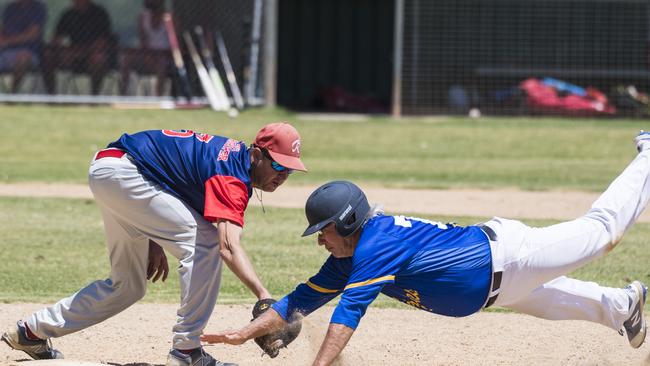 Toowoomba Rangers player Darryl Luchterhand (left) gets Alan Lawton of Mt Gravatt Eagles out in GBL division five baseball at Commonwealth Oval, Sunday, November 29, 2020. Picture: Kevin Farmer