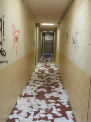 Papers scattered down a hallway.