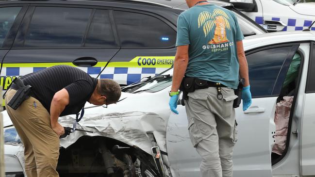 Police examine a ute after a pursuit that ended on the Surfcoast Highway at Armstrong Creek. Picture: Alison Wynd]