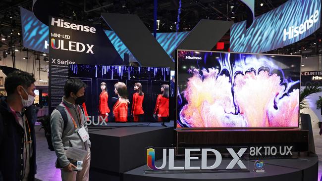 Attendees look at 8K TV displays at the Hisense booth at CES 2023 at the Las Vegas Convention Center on January 05, 2023 in Las Vegas, Nevada. (Photo by ALEX WONG / GETTY IMAGES NORTH AMERICA / Getty Images via AFP)