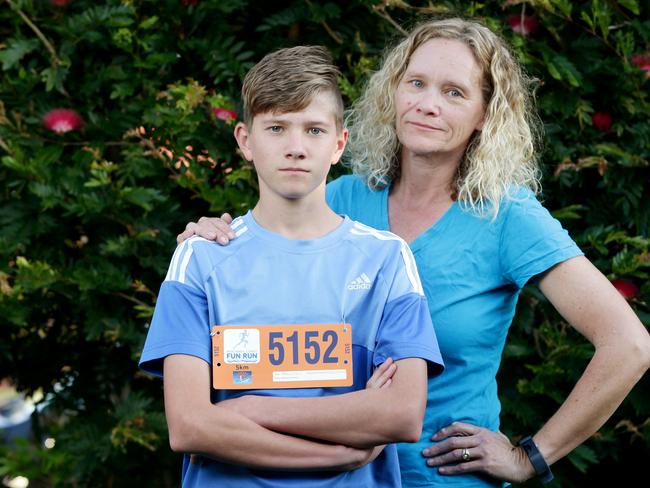 Reece Mairs, 12, with mum Kylie. Reece was pushed by MP Andrew Laming in a fun run. Picture: AAP Image/Steve Pohlner