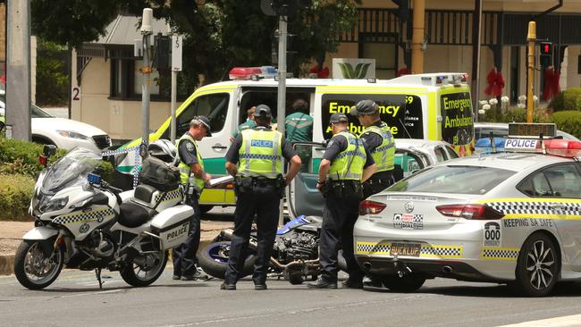 Police examine the motorcycle, after it collided with a car on the corner of Fullarton Road and The Parade at Norwood. Picture: Dean Martin