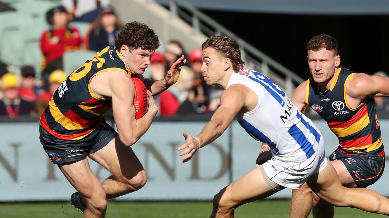 Young Crow Harry Schoenberg breaks away from Hugh Greenwood. Picture: Sarah Reed/AFL Photos