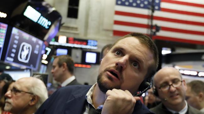 FILE- In this Oct. 19, 2018, file photo trader Michael Milano works on the floor of the New York Stock Exchange. The U.S. stock market opens at 9:30 a.m. EDT on Thursday, Oct. 25. (AP Photo/Richard Drew, File)