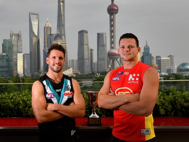 Port Adelaide Power player Travis Boak and Gold Coast Suns player Steven May pose for a photograph overlooking the skyline in Shanghai, China, Thursday, May 17, 2018. (AAP Image/David Mariuz) NO ARCHIVING