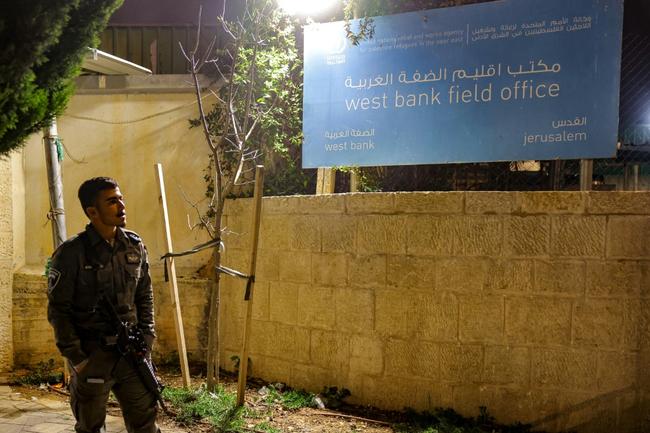 An Israeli border guard stands by during a protest by Israeli right-wing activists (not in frame) outside the West Bank field office of the United Nations Relief and Works Agency for Palestine Refugees (UNRWA) in Jerusalem