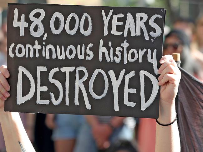 Protesters are seen during a rally outside the Rio Tinto office in Perth, Tuesday, June 9, 2020.. Rio Tinto recently detonated explosives in an area of the Juukan Gorge in the Pilbara, destroying two ancient deep-time rock shelters, much to the distress of the Puutu Kunti Kurrama and Pinikura people. (AAP Image/Richard Wainwright) NO ARCHIVING