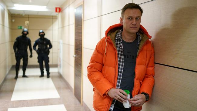 Security agents keep a close eye on Russian opposition leader Alexei Navalny in his Moscow offices last December. Picture: AFP