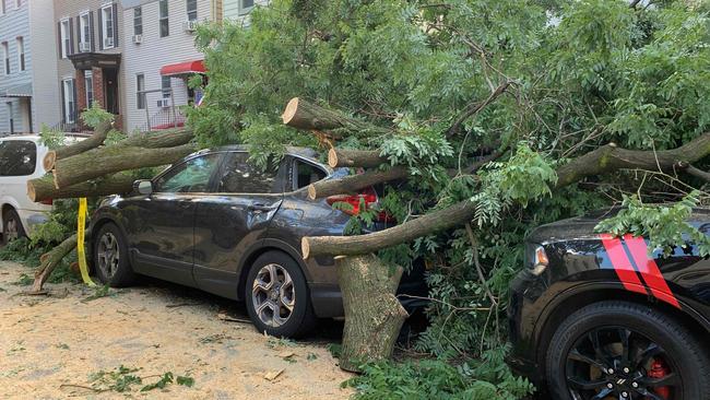 saias pounded the US eastern seaboard with driving rain and strong winds, causing trees to fall on cars in New York. Picture: Diane Desobeau/AFP