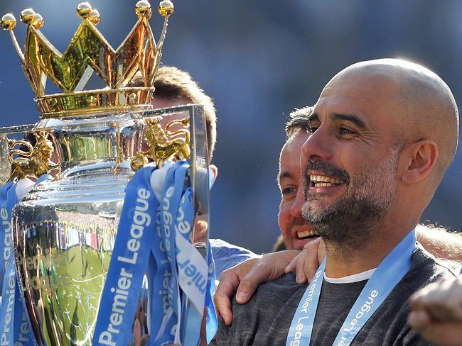 Manchester City coach Pep Guardiola lifts the English Premier League trophy after the English Premier League soccer match between Brighton and Manchester City at the AMEX Stadium in Brighton, England, Sunday, May 12, 2019. Manchester City defeated Brighton 4-1 to win the championship. (AP Photo/Frank Augstein)