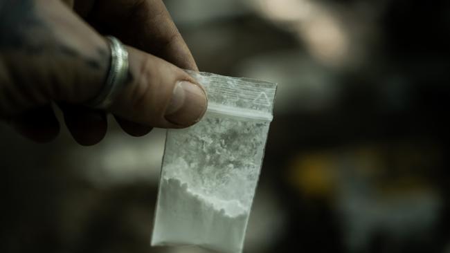 Generic crime Istock  -  Man holding in hands small bag with cocaine