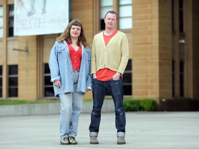 Artist Zoe Marni Robertson and Primavera curator Mitch Cairns outside the Museum of Contemporary Art. On the banner behind is Robertson’s work, Sexualised Workers' Mural (Watchmen and Street Sweepers). Picture: Christian Gilles