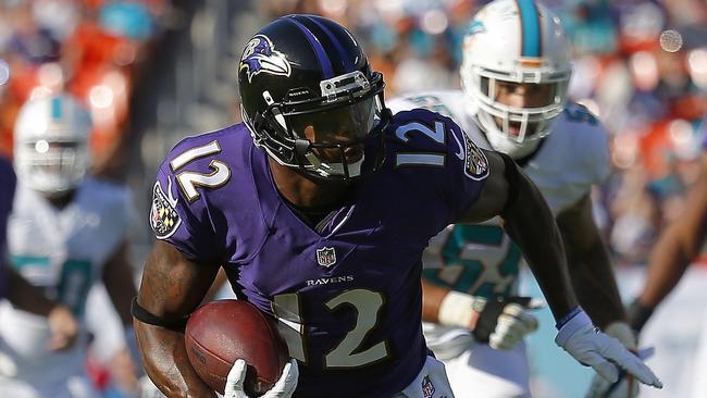 Wide receiver Jacoby Jones #12 of the Baltimore Ravens picks up second-half yardage.