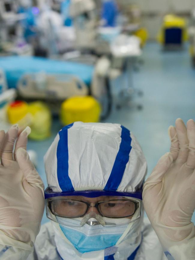 A nurse adjusting his goggles in an intensive care unit treating COVID-19 coronavirus patients at a hospital in Wuhan. Picture: AFP