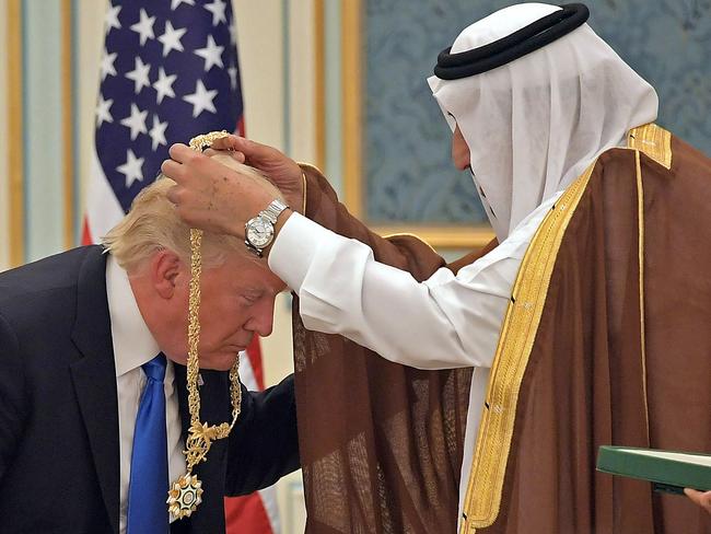 US President Donald Trump receives the Order of Abdulaziz al-Saud medal from Saudi Arabia's King Salman bin Abdulaziz al-Saud at the Saudi Royal Court in Riyadh on May 20, 2017. Picture: AFP / Mandel Ngan.