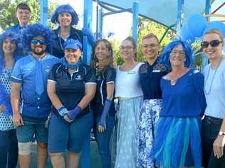 Brenda Venter, Stacey Walsh, Matt O'Brien, Sam Avery, Anne-Marie Johnstone, Susan Neill, Claudia Mullen, Clancy Conlon, Donna Purcell, and Helen Reece of Autism Queensland go blue for Autism Month. Picture: Jann Houley