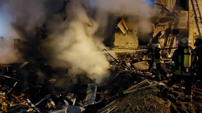 Firefighters extinguish a blaze at a damaged residential building at Koshytsa Street, a suburb of the Ukrainian capital Kyiv. Picture: Handout/Ukraine Emergency Ministry Press Service/AFP