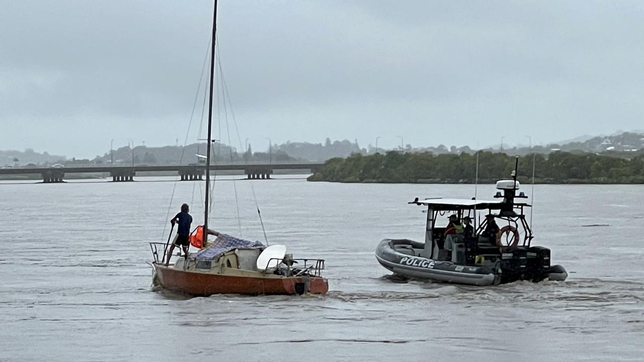 Yeppoon water police officers chat with a man living on a yacht in the swollen Pioneer River on Tuesday morning, January 13, 2023. Picture: Janessa Ekert