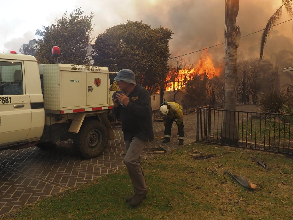 A bush fire rages in the town of Tathra on Sunday afternoon, March 18, 2018. Picture: John Ford