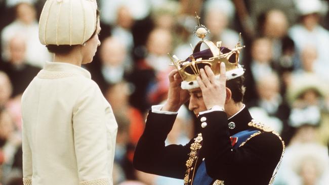 Prince Charles kneels before Queen Elizabeth as she crowns him Prince of Wales at Caernarvon Castle in 1969. Picture: Getty Images