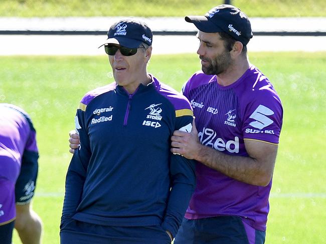 Craig Bellamy and Cameron Smith share a moment during a training session at Sunshine Coast Stadium. Picture: Bradley Kanaris/Getty Images