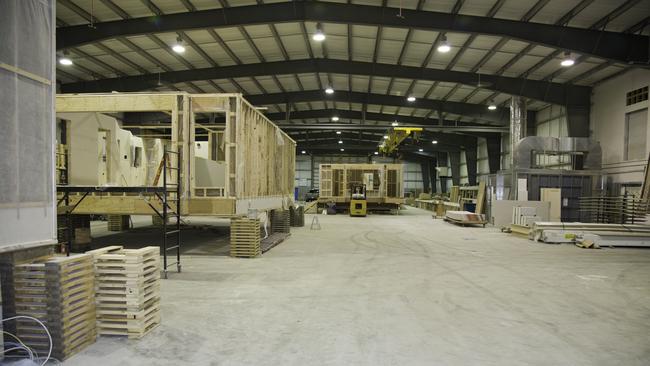 Modular homes being manufactured in a factory.