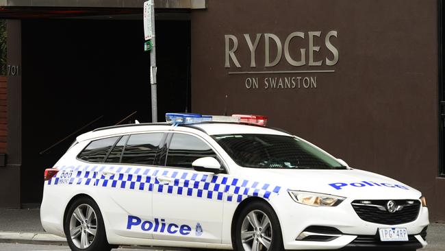 MELBOURNE, AUSTRALIA - JULY 14: A police car sits outside the Rydges on Swanston hotel on July 14, 2020 in Melbourne, Australia. The hotel is linked to being one of the sources of Melbourne's coronavirus outbreaks where it accomodated returning overseas travellers for a 14 day quarantine period. Victoria has recorded 270 new coronavirus cases, bringing Australia's national COVID-19 total above 10,000 cases. Metropolitan Melbourne and the Mitchell shire are currently in lockdown following the rise in COVID-19 cases through community transmissions. The new restrictions came into effect on Thursday 9 July, with residents in lockdown areas under stay at home orders until 19 August. People are only able to leave home have for exercise or work, to buy essential items including food or to access childcare and healthcare. Gatherings of groups of more than two or more than a household group are not permitted while school holidays have been extended by a week so children remain home. Retail can remain open and markets are permitted to open for food and drink only. Cafes, restaurants, pubs, clubs and bars are back to takeaway only. Eight public housing estates that have been under hard lockdown have reopened subject to stage 3 COVID-19 restrictions in line with the rest of Melbourne, while the tower at Alfred Street remains under hard lockdown while health authorities continue COVID-19 testing. (Photo by Quinn Rooney/Getty Images)