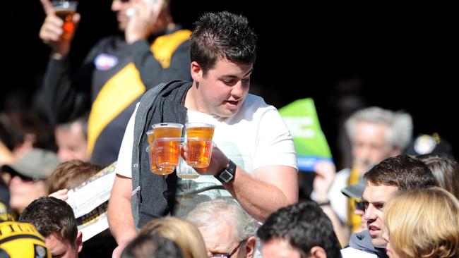 Beers can be easy to spill when served in plastic cups. Picture: AAP